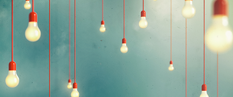 Light bulbs hanging from red cords